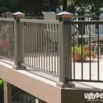 A raised outdoor deck with metal railings and decorative posts, featuring patio chairs and potted plants—perfect inspiration for your next DIY Deck Materials project. The logo uglyDeck.com appears in the bottom right corner.