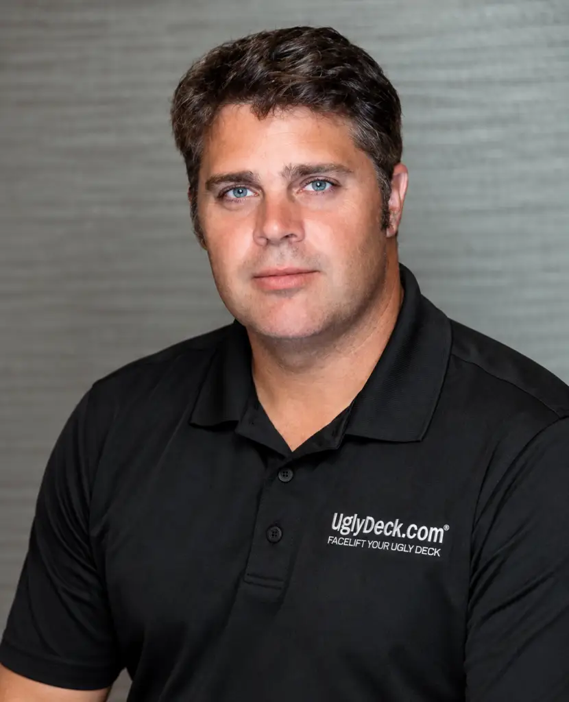 A man wearing a black polo shirt with the UglyDeck.com logo.